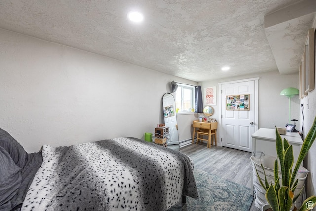 3061 W 13800 S, Bluffdale, UT 84065 - bedroom featuring recessed lighting, a textured ceiling, baseboard heating, and wood finished floors