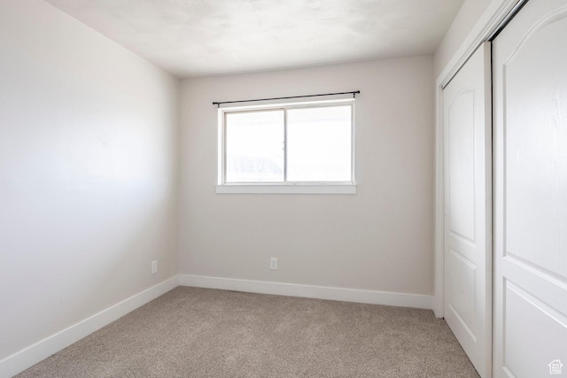 3061 W 13800 S, Bluffdale, UT 84065 - unfurnished bedroom featuring a closet, baseboards, and light colored carpet