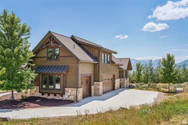 1075 N Oquirrh Mountain Dr Unit 64, Heber City, UT 84032 - view of front facade featuring stone siding, concrete driveway, an attached garage, and a mountain view