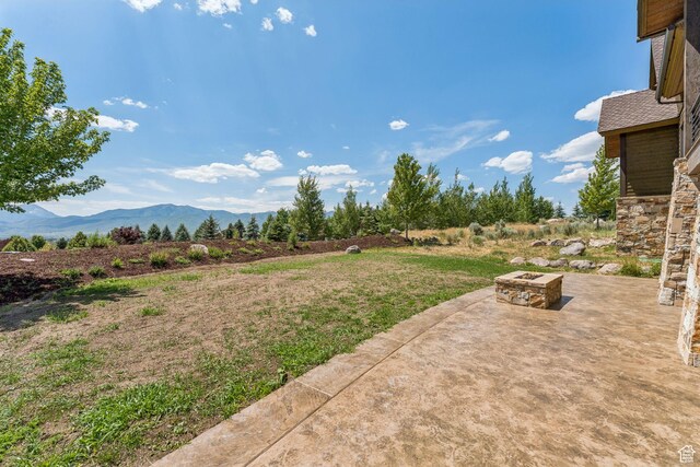 1075 N Oquirrh Mountain Dr Unit 64, Heber City, UT 84032 - view of yard with an outdoor fire pit, a patio area, and a mountain view