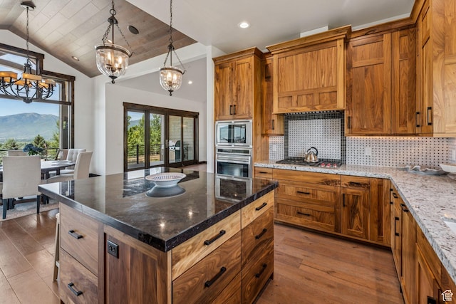 1075 N Oquirrh Mountain Dr Unit 64, Heber City, UT 84032 - kitchen with appliances with stainless steel finishes, a chandelier, hardwood / wood-style flooring, lofted ceiling, and backsplash