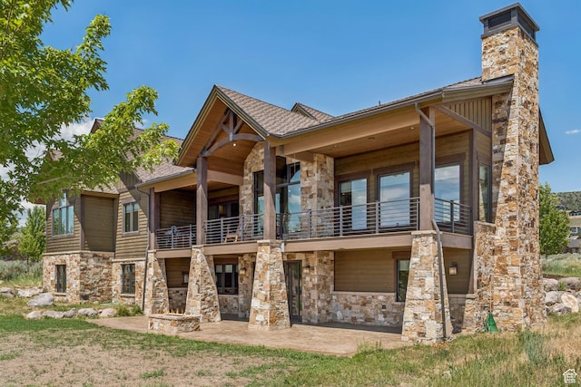 1075 N Oquirrh Mountain Dr Unit 64, Heber City, UT 84032 - back of house featuring a balcony, stone siding, a patio area, and a chimney