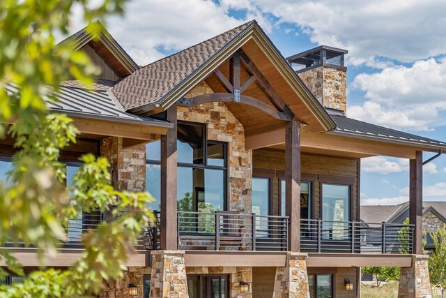 1075 N Oquirrh Mountain Dr Unit 64, Heber City, UT 84032 - view of exterior entry with a standing seam roof, stone siding, and a metal roof