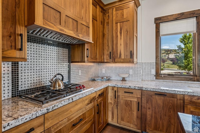 1075 N Oquirrh Mountain Dr Unit 64, Heber City, UT 84032 - kitchen with custom range hood, stainless steel gas cooktop, tasteful backsplash, and light stone counters