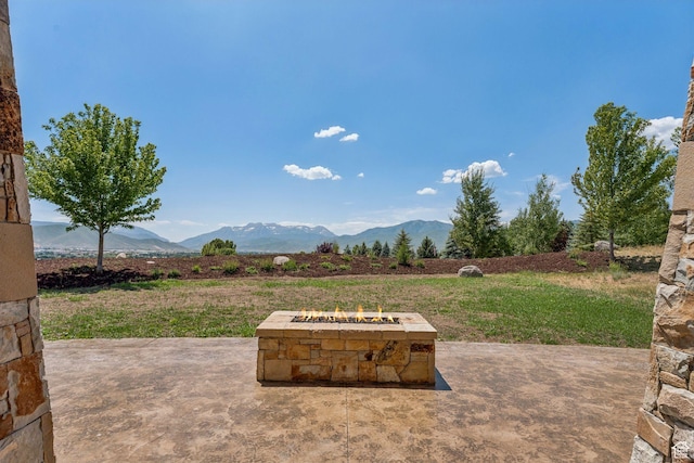 1075 N Oquirrh Mountain Dr Unit 64, Heber City, UT 84032 - view of patio with an outdoor fire pit and a mountain view