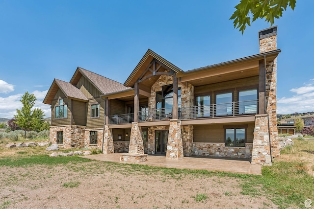1075 N Oquirrh Mountain Dr Unit 64, Heber City, UT 84032 - rear view of house with a balcony, stone siding, a patio area, board and batten siding, and a chimney