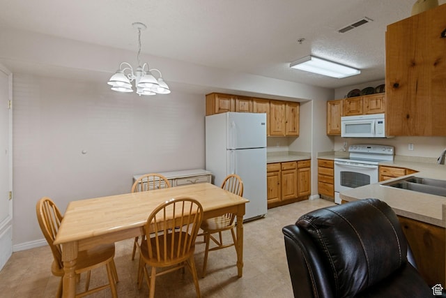 8246 N Cedar Springs Rd Unit 1, Eagle Mountain, UT 84005 - kitchen with white appliances, visible vents, an inviting chandelier, a sink, and light countertops