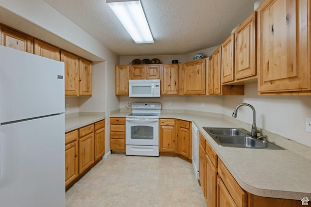 8246 N Cedar Springs Rd Unit 1, Eagle Mountain, UT 84005 - kitchen with light floors, light countertops, white appliances, a textured ceiling, and a sink