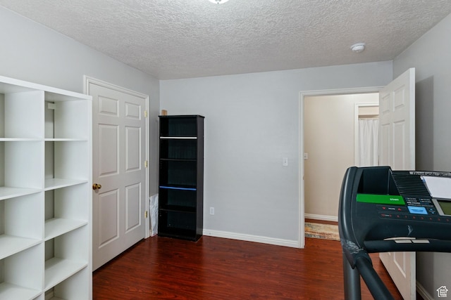 8246 N Cedar Springs Rd Unit 1, Eagle Mountain, UT 84005 - exercise room featuring baseboards, a textured ceiling, and wood finished floors