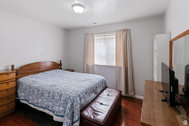 8246 N Cedar Springs Rd Unit 1, Eagle Mountain, UT 84005 - bedroom featuring dark wood finished floors, visible vents, a textured ceiling, and baseboards