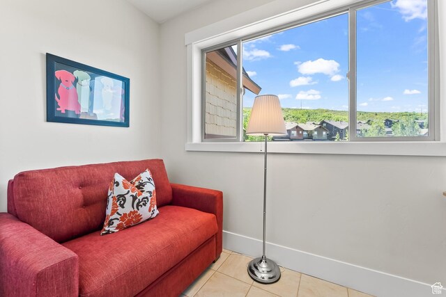 living area with tile patterned flooring and baseboards