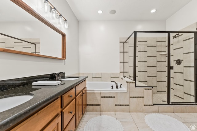 full bath featuring tile patterned flooring, a bath, a stall shower, and a sink
