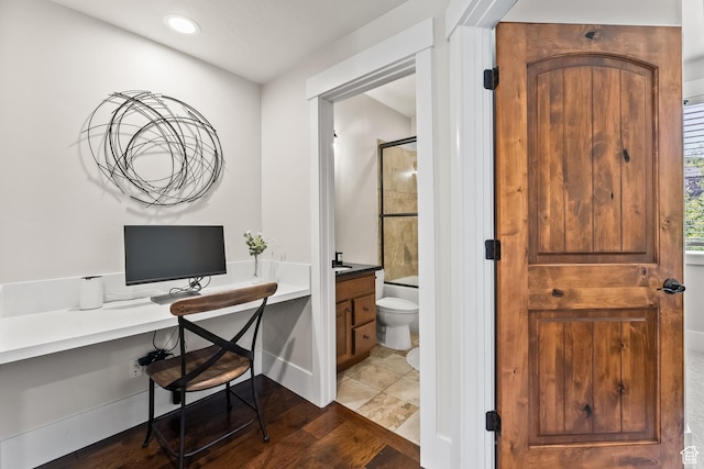 full bath featuring bath / shower combo with glass door, toilet, wood finished floors, and vanity