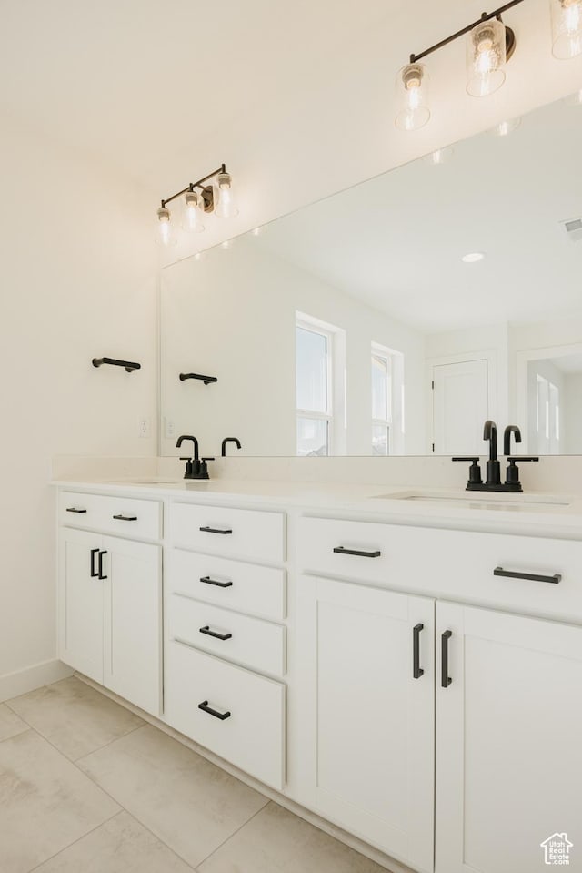 bathroom with tile patterned flooring, double vanity, and baseboards