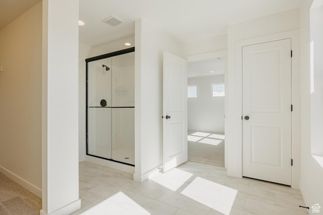 bathroom featuring a shower stall, baseboards, and recessed lighting