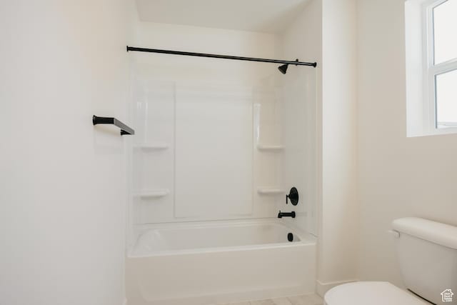 full bathroom with toilet and baseboards