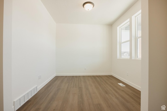 empty room with wood finished floors and baseboards