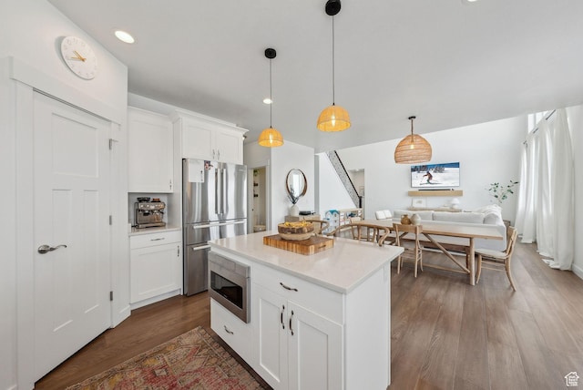 541 N 1400 E, Heber City, UT 84032 - kitchen featuring dark wood-style floors, stainless steel appliances, white cabinetry, decorative light fixtures, and a center island