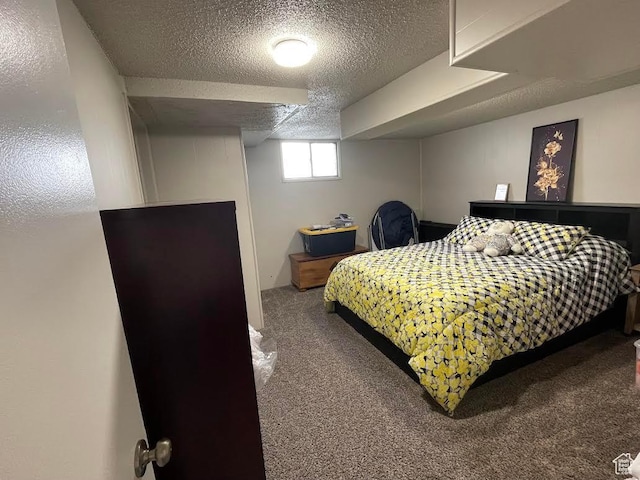 bedroom featuring carpet and a textured ceiling