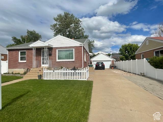 bungalow-style home featuring brick siding, an outdoor structure, and a garage