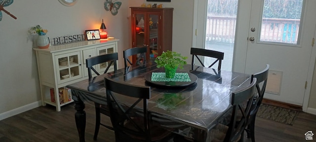 dining space with wood finished floors and baseboards