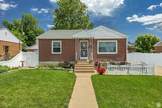 357 S 600 E, Clearfield, UT 84015 - bungalow-style home with brick siding, a fenced backyard, and a gate