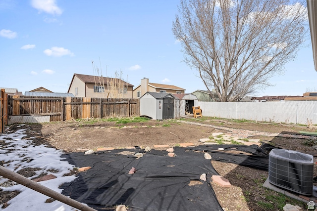 2670 S Melville Dr, Magna, UT 84044 - view of yard featuring a fenced backyard, central air condition unit, a storage unit, and an outdoor structure