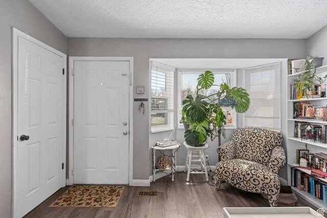 2670 S Melville Dr, Magna, UT 84044 - foyer entrance featuring wood finished floors, baseboards, and a textured ceiling