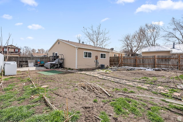 2670 S Melville Dr, Magna, UT 84044 - back of property featuring a patio area, central air condition unit, and a fenced backyard
