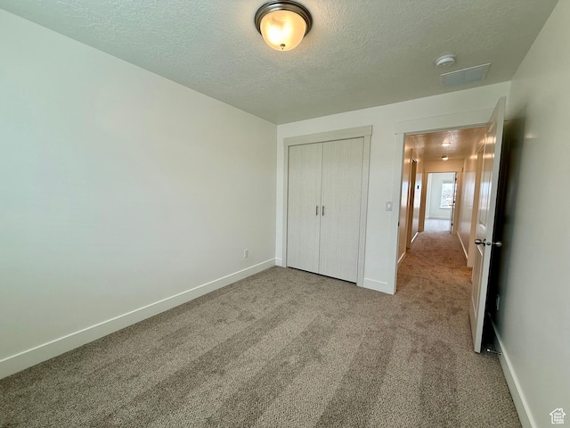 3362 S 1010 W, Nibley, UT 84321 - unfurnished bedroom with baseboards, a textured ceiling, and carpet flooring