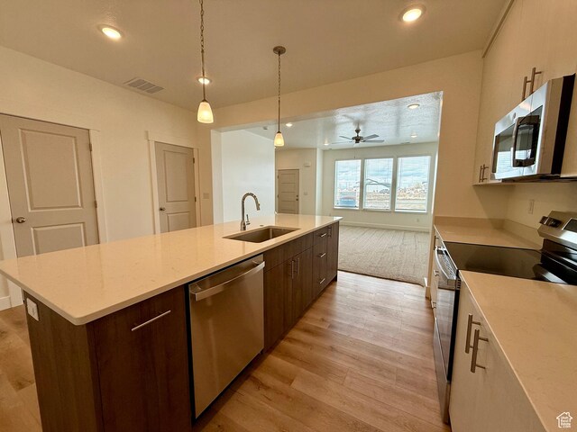 3362 S 1010 W, Nibley, UT 84321 - kitchen with visible vents, a center island with sink, a sink, open floor plan, and stainless steel appliances