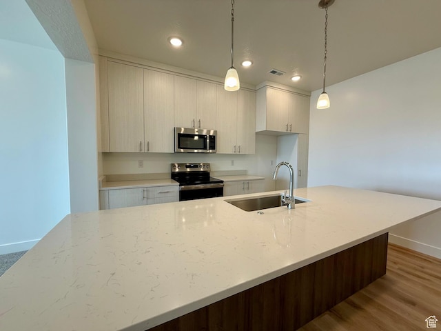 3362 S 1010 W, Nibley, UT 84321 - kitchen featuring visible vents, pendant lighting, wood finished floors, stainless steel appliances, and a sink