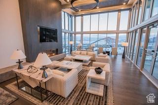 2752 W High Mountain Rd Unit 306, Park City, UT 84098 - living room featuring floor to ceiling windows, wood finished floors, and a towering ceiling