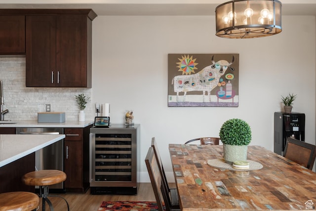 8077 Courtyard Loop Unit 11, Park City, UT 84098 - dining room featuring beverage cooler, wood finished floors, and a chandelier