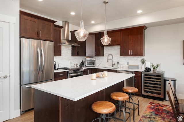 8077 Courtyard Loop Unit 11, Park City, UT 84098 - kitchen with stainless steel appliances, beverage cooler, wall chimney range hood, a sink, and light wood-type flooring