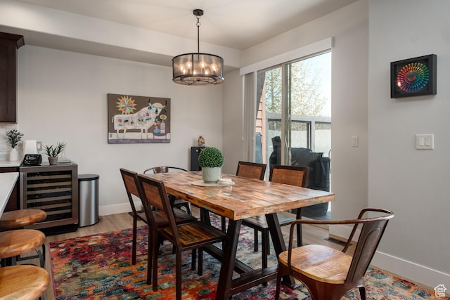 8077 Courtyard Loop Unit 11, Park City, UT 84098 - dining area featuring beverage cooler, baseboards, light wood-type flooring, and a chandelier