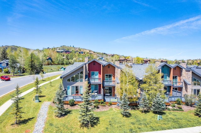 8077 Courtyard Loop Unit 11, Park City, UT 84098 - view of front of property featuring a balcony, a chimney, a front lawn, and a residential view
