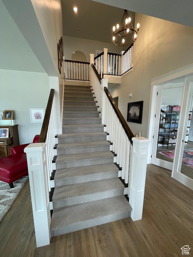 10887 S Lamond Dr, South Jordan, UT 84009 - stairs featuring a chandelier, a high ceiling, and wood finished floors
