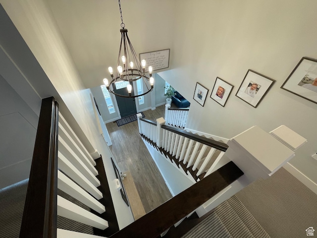 10887 S Lamond Dr, South Jordan, UT 84009 - stairs featuring a high ceiling, a notable chandelier, wood finished floors, and baseboards