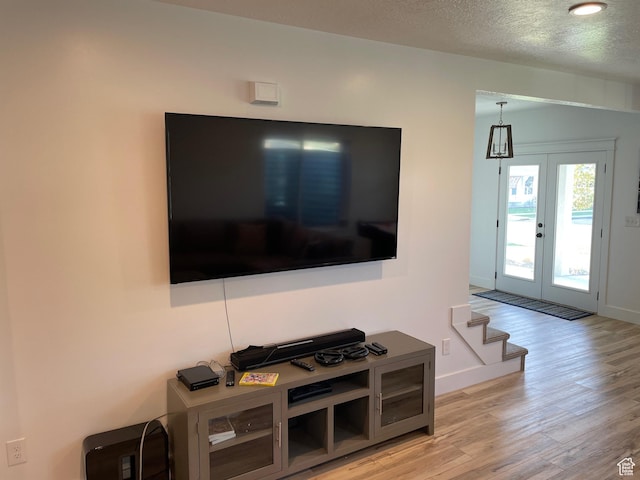 10887 S Lamond Dr, South Jordan, UT 84009 - living area with stairway, baseboards, light wood-style floors, and a textured ceiling