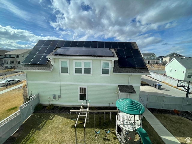 10887 S Lamond Dr, South Jordan, UT 84009 - back of house with solar panels, a fenced backyard, and roof with shingles