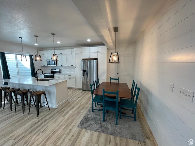 10887 S Lamond Dr, South Jordan, UT 84009 - dining space featuring recessed lighting, a textured ceiling, and light wood-style flooring