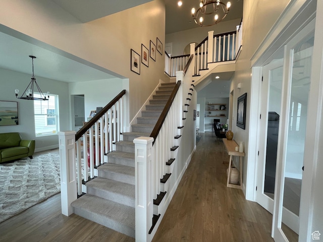 10887 S Lamond Dr, South Jordan, UT 84009 - staircase with baseboards, a notable chandelier, and wood finished floors