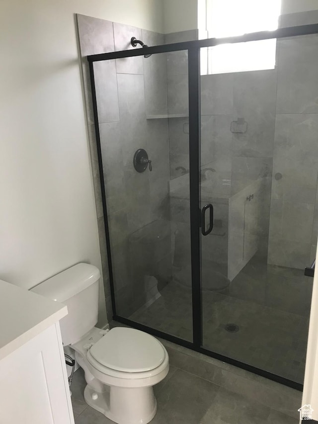 10887 S Lamond Dr, South Jordan, UT 84009 - full bathroom with tile patterned floors, a stall shower, toilet, and vanity