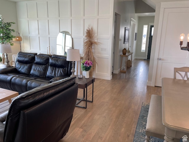 10887 S Lamond Dr, South Jordan, UT 84009 - living area with a decorative wall, light wood-style flooring, and baseboards