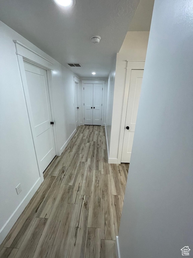 10887 S Lamond Dr, South Jordan, UT 84009 - hallway featuring wood finished floors, visible vents, and baseboards