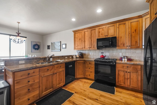 1056 W Lime Canyon Rd, Midway, UT 84049 - kitchen featuring a sink, brown cabinetry, black appliances, and a peninsula
