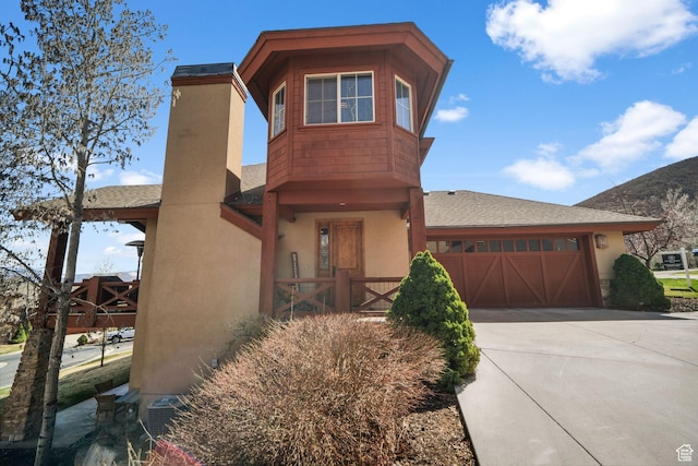 1056 W Lime Canyon Rd, Midway, UT 84049 - view of front of home with central AC unit, driveway, stucco siding, and an attached garage