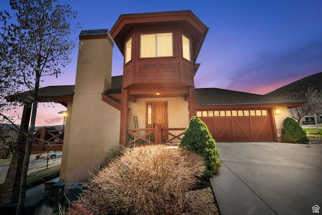 1056 W Lime Canyon Rd, Midway, UT 84049 - view of front of home with an attached garage, concrete driveway, and stucco siding