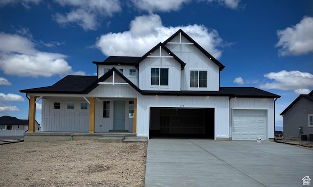 modern inspired farmhouse with board and batten siding, a porch, driveway, and a garage